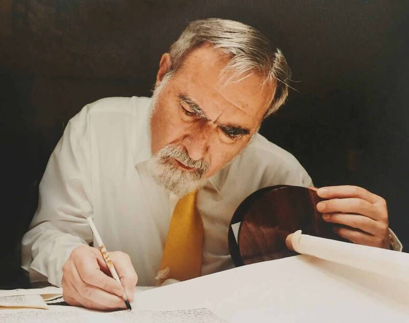 Rabbi Sacks writing in the Torah scroll a letter in the scroll sofer scribe writing scaled 1