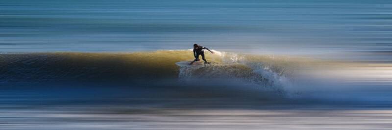 surfer riding the wave bravery risk adventure challenge crest ocean danger