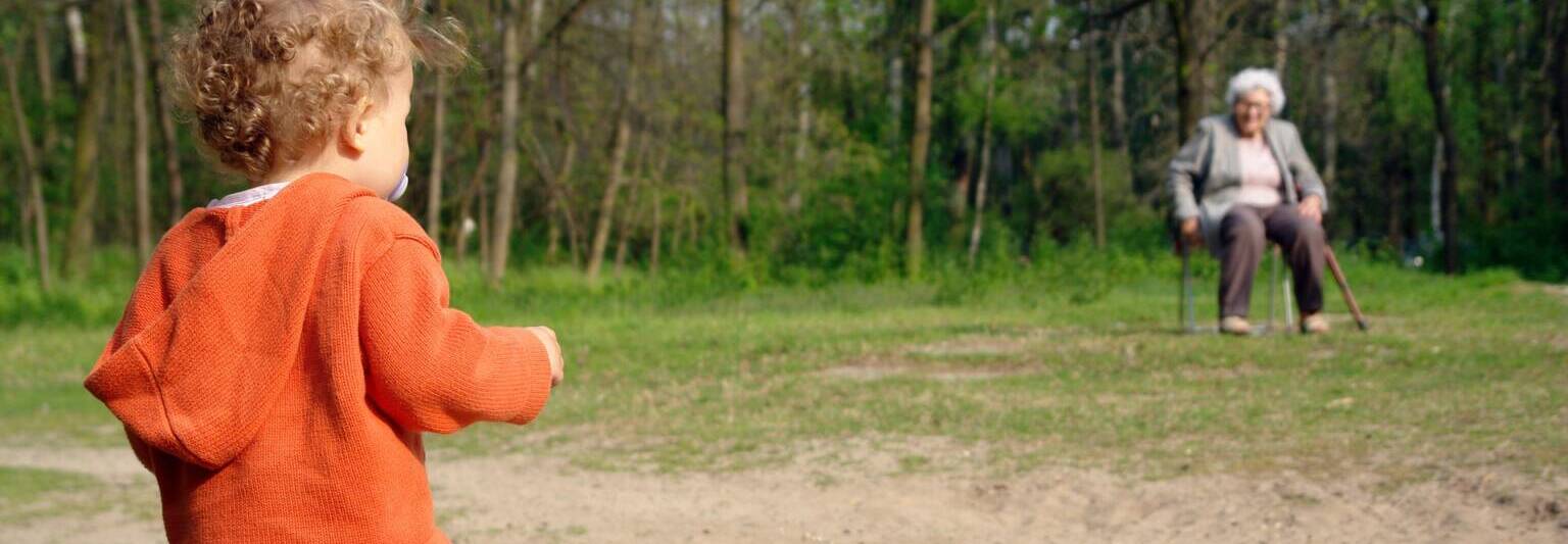 generation grandma and grandchild family outing park bench toddler