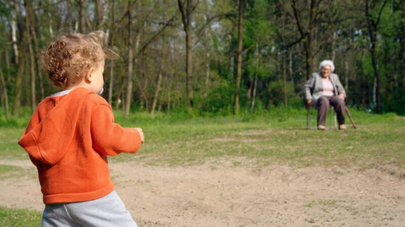 generation grandma and grandchild family outing park bench toddler