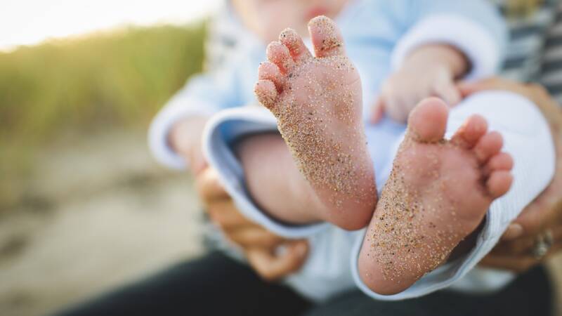baby infant feet generations child with sand granules marks of history grains unclean dirty toes