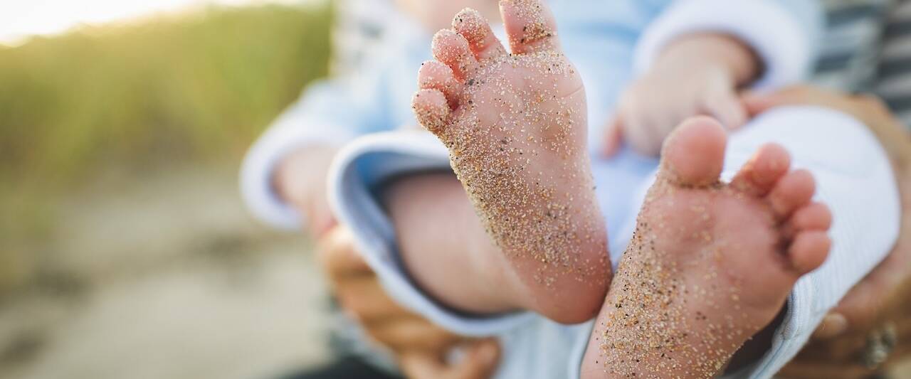 baby infant feet generations child with sand granules marks of history grains unclean dirty toes 1