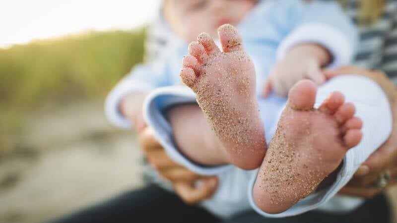 baby infant feet generations child with sand granules marks of history grains unclean dirty toes 1