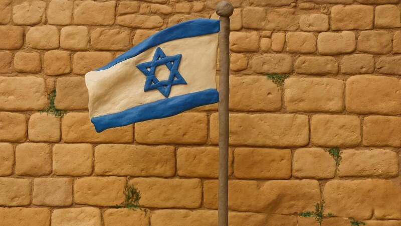 israeli flag in front of the kotel in jerusalem stone